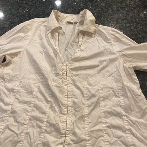 Fitted stretch white blouse with hook and eye closure and ruffle accents